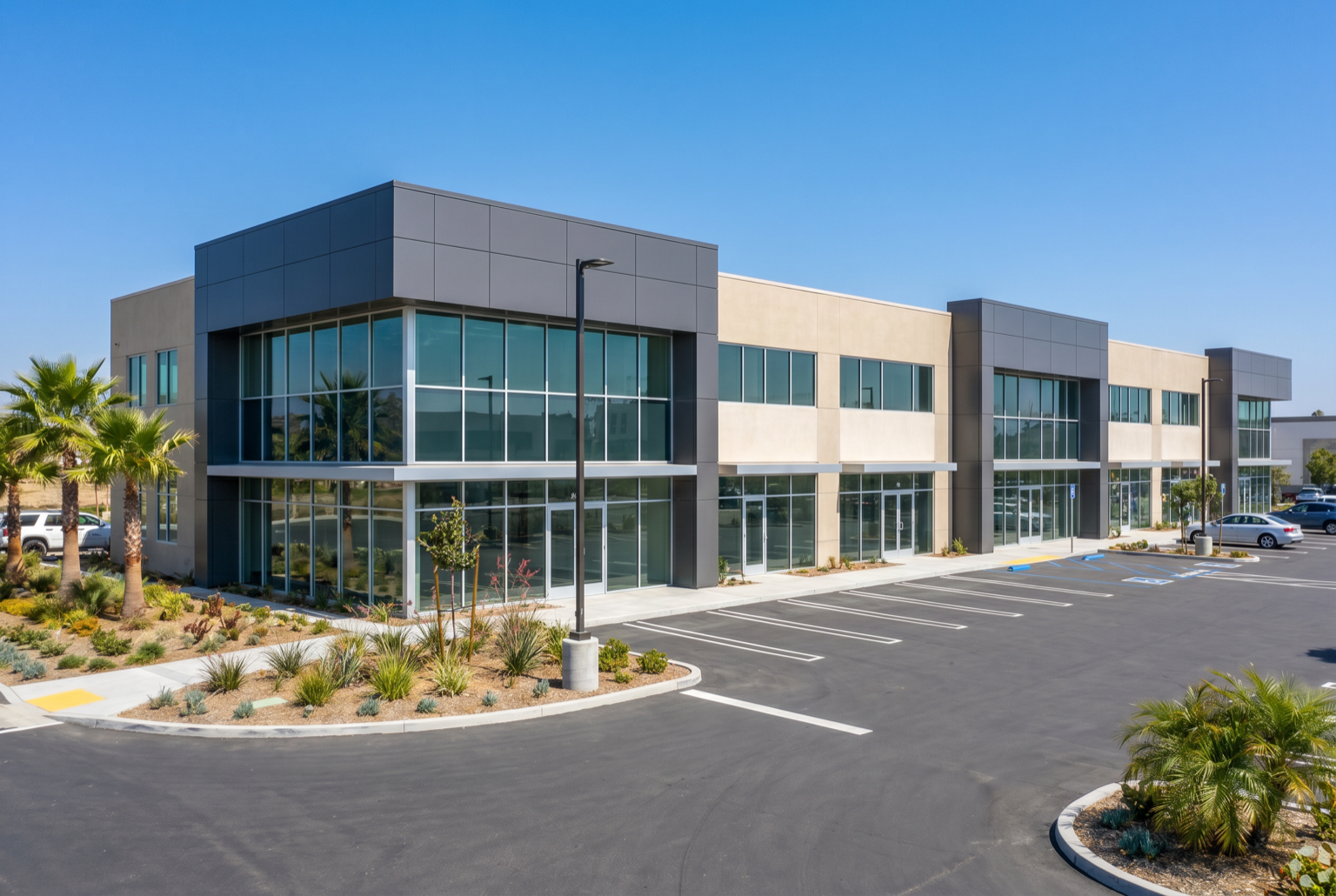 Completed two-story commercial office and retail building with a glass storefront and parking