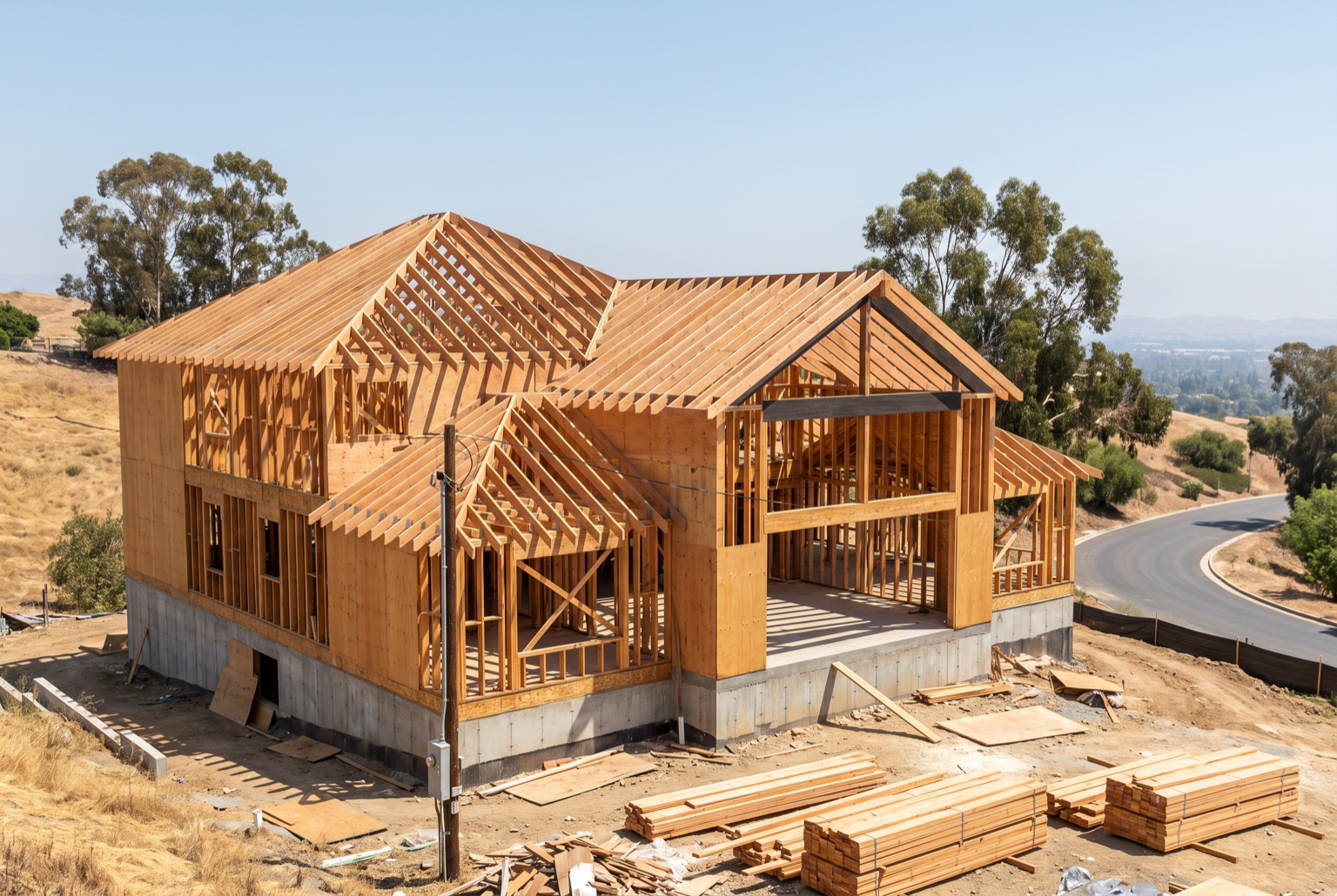 Large custom home at framing stage with engineered beams and complex roof rafters